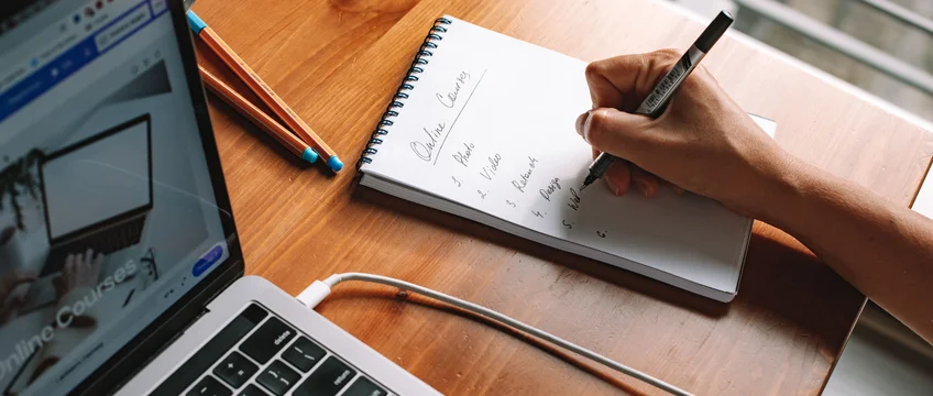 Person researching free Coursera courses with certificates on a laptop in South Africa