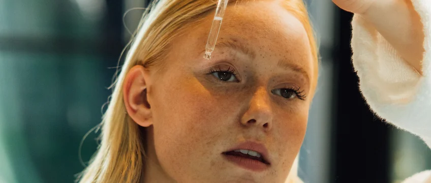Woman applying peptide skincare serum with a dropper safely in South Africa