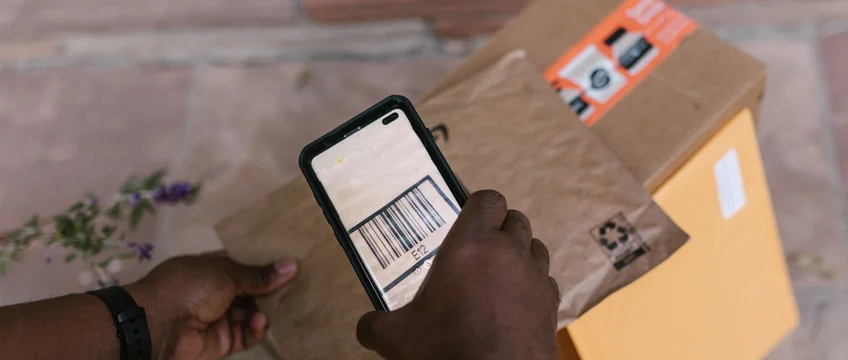 Courier scanning a package for SHEIN delivery tracking in South Africa
