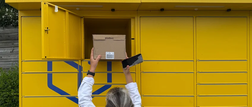 Woman collecting a parcel from a PUDO locker pickup point in South Africa