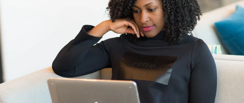 South African freelancer working on a laptop from home, building a side hustle