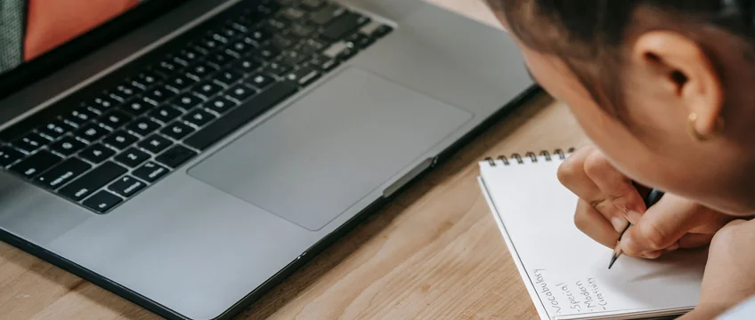 Person studying an online course on a laptop, representing self-directed reskilling in South Africa
